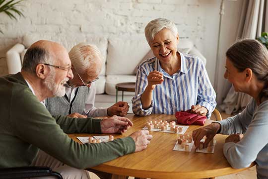 Seniors playing a board game.