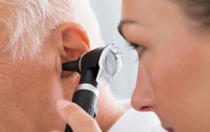 Doctor examining a patient's ear.